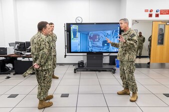 Chief of Naval Personnel Vice Adm. Rick Cheeseman, left, speaks with Rear Adm. Pete Garvin, right, commander, Naval Education and Training Command (NETC), during a demonstration by Chief Aviation Support Equipment Technician Kyle Fowler, center-left, assigned to Naval Air Technical Training Center (NATTC), on the Multipurpose Reconfigurable Training System 3D® simulation during a tour of NATTC as part of a visit to Pensacola area Naval Education and Training Commands, Jan. 26, 2023. NETC's mission is to recruit, train and deliver those who serve our nation, taking them from street-to-fleet by transforming civilians into highly skilled, operational and combat ready warfighters. Multipurpose Reconfigurable Training System 3D®, MRTS 3D®, and the MRTS 3D logo are registered trademarks of the U.S. Navy. (United States Navy photo by Mass Communication Specialist 2nd Class Zachary Melvin)