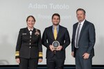 Adam Tutolo, C&E lead commodity support liaison, center, poses with DLA Director Navy Vice Adm. Michelle C. Skubic, left, and DLA Vice Director Brad Bunn, right, after receiving the Employee of the Year award during DLA's 55th Annual Employee Recognition Awards held Jan 26 at the McNamara Headquarters Complex on Fort Belvoir, Va. (Photos by DLA photographer Christopher Lynch)