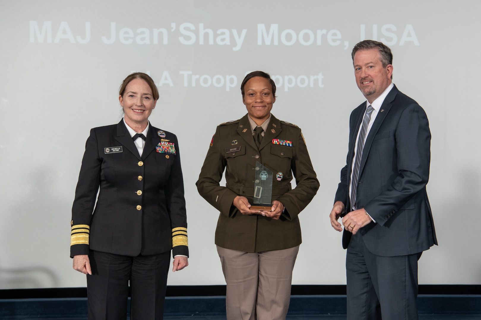 Army Maj. Jean’Shay D. Moore, C&E acquisition officer, center, poses with DLA Director Navy Vice Adm. Michelle C. Skubic, left, and DLA Vice Director Brad Bunn, right, after receiving the Field Grade Officer of the Year award during DLA's 55th Annual Employee Recognition Awards held Jan 26 at the McNamara Headquarters Complex on Fort Belvoir, Va. (Photos by DLA photographer Christopher Lynch)
