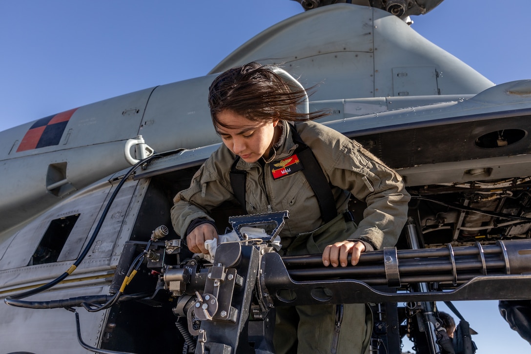 U.S. Marine Corps Cpl. Midsi MartinezVasquez, a UH-1Y Venom crew chief with Marine Light Attack Helicopter Squadron (HMLA) 167, applies grease to a GAU-17 machine gun at Marine Corps Air Station Yuma, Arizona, Jan. 26, 2023. HMLA-167 trained to increase proficiency during a unit-level deployment for training (DFT). The purpose of the DFT was to increase the squadron’s proficiency in expeditionary close-air support, shore-based operations, and defensive-air maneuvering. HMLA-167 is a subordinate unit of 2nd Marine Aircraft Wing, the aviation combat element of II Marine Expeditionary Force. (U.S. Marine Corps photo by Cpl. Caleb Stelter)