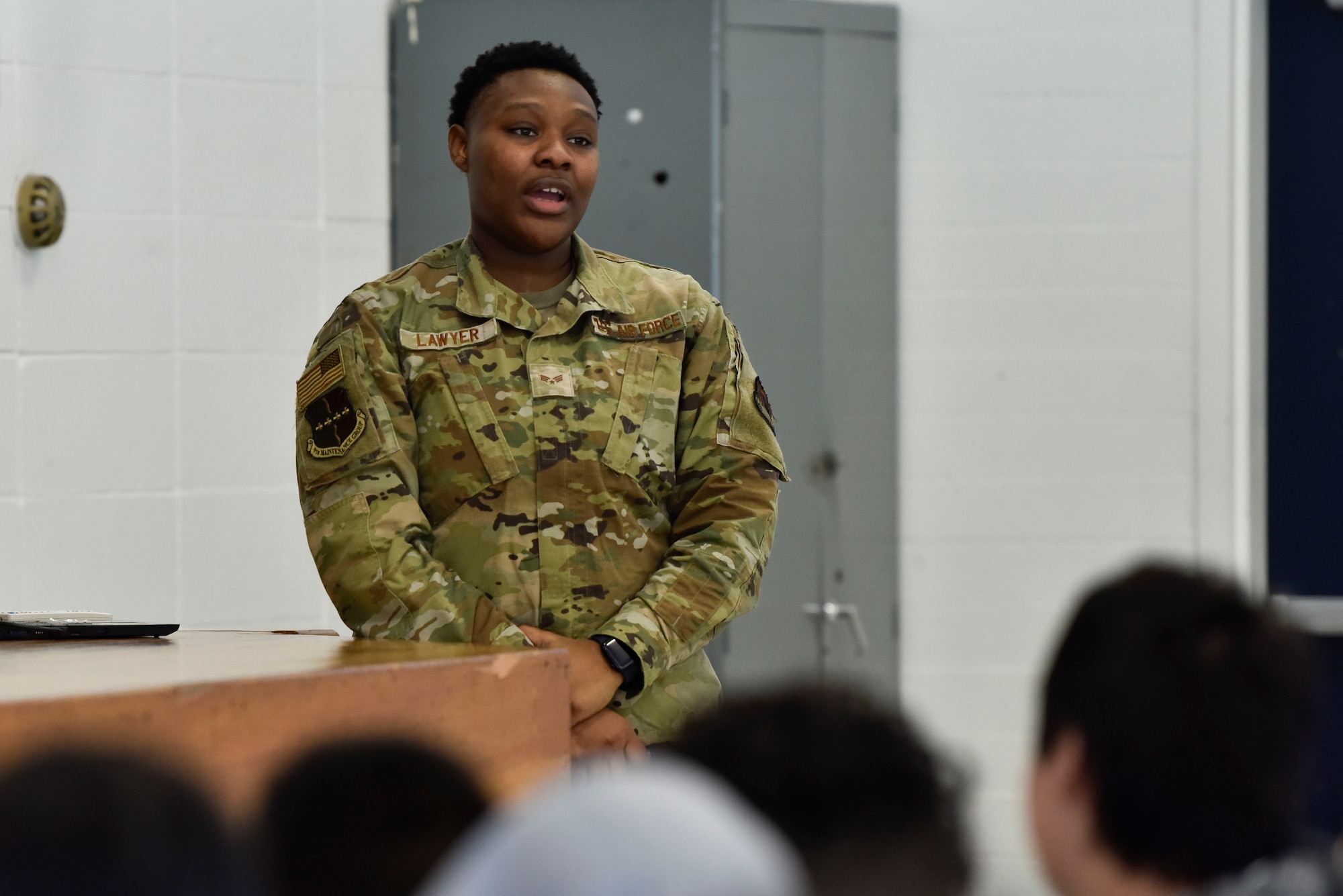 U.S. Air Force Senior Airman Labrianna Lawyer, 9th Maintenance Group weapons system controller, explains the military rank structure to Redwood Middle School students in Napa Valley, California, Jan. 25, 2023.