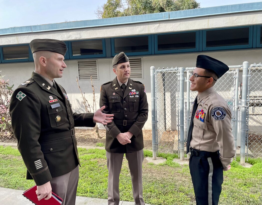 Col. Chad Caldwell, Sacramento District commander, left, and Lt. Col. Kevin Arnett, San Francisco District commander, center, speak to Southeast Academy High School senior Erick Estrada during a Jan. 13 visit to the school in Norwalk, California.