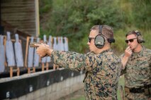 U.S. Marine Corps Sgt. Samuel Nelson, Marine Corps Shooting Team Instructor, demonstrates pistol techniques during the Marine Corps Marksmanship Competition - Pacific Shooting Team Training at Crater Range, Marine Corps Base Hawaii, Jan. 26, 2023. The MCMC-Pacific is one of four regional competitions throughout the Marine Corps in which U.S. service members and the Pacific's best shooters participate in a small arms marksmanship competition each year. (U.S. Marine Corps photo by Cpl. Holly Moore)