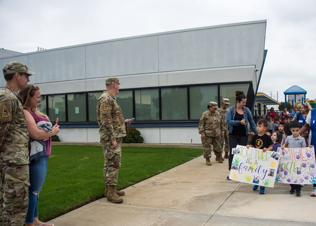 Children from the CDC walk in a parade on base.
