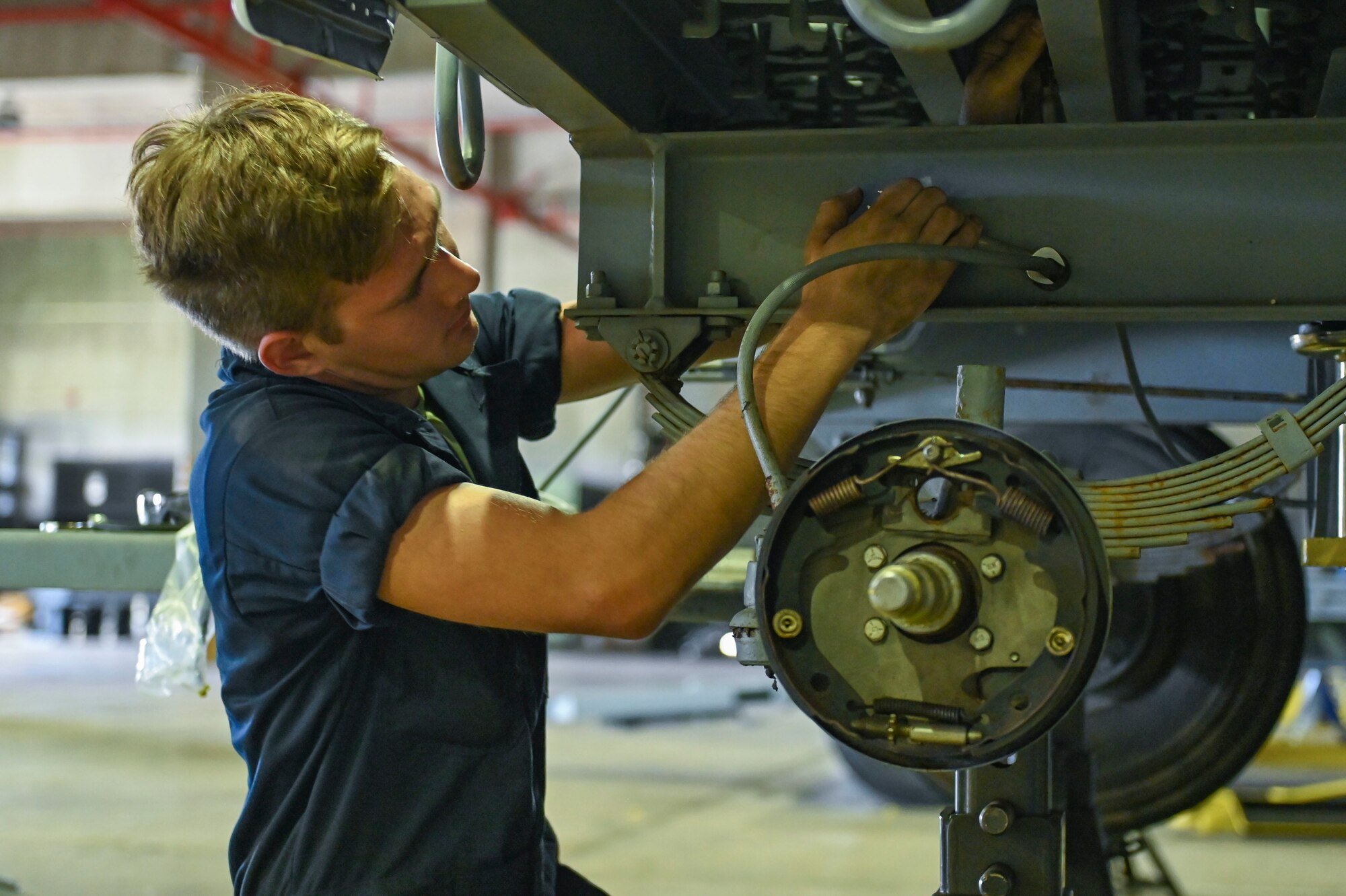 Airman removed a stainless steel brake line from a trailer