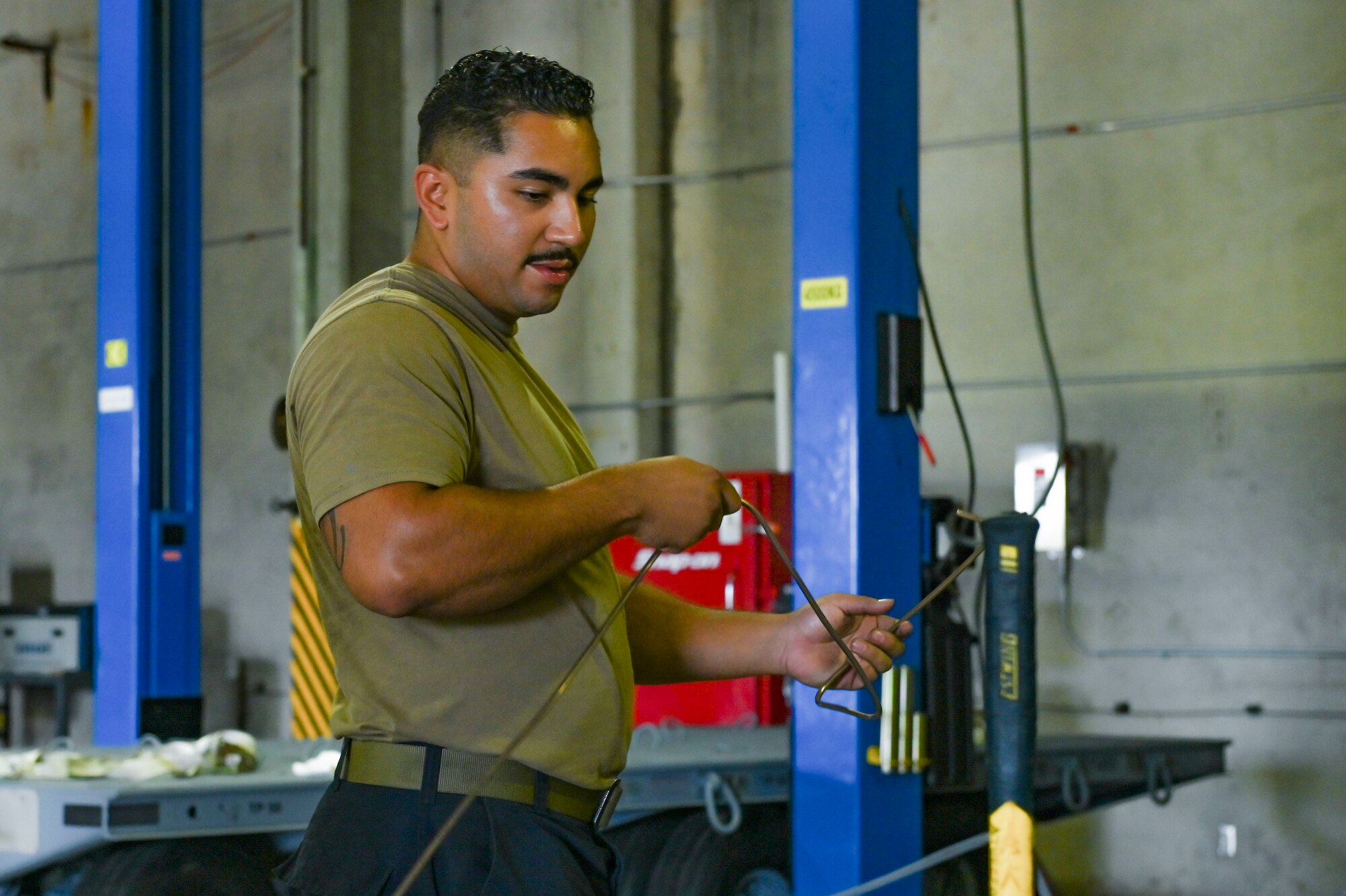 Airman inspects new copper nickel brake line.