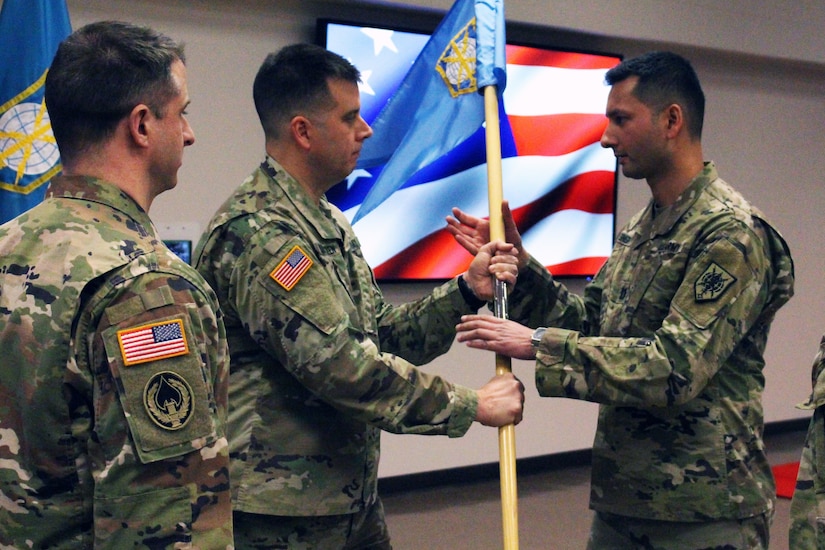 Solder passing the unit guidon while standing to the incoming commandant during a ceremony.