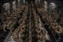 U.S. Army Soldiers from the 82nd Airborne Division prepare to enter a C-17 Globemaster III at Pope Army Airfield, North Carolina, Jan. 23, 2023. Battalion Mass Tactical Week had six aircraft participating with three C-130J Super Hercules from Dyess Air Force Base, Texas, and three C-17s from Joint Base Charleston, South Carolina. (U.S. Air Force photo by Airman 1st Class Ryan Hayman)