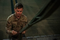 U.S. Air Force Master Sgt. Andy Cline, 40th Airlift Squadron loadmaster, ties a parachute on a C-130J Super Hercules at Pope Army Airfield, North Carolina, Jan. 26, 2023. Battalion Mass Tactical Week ensured the proper training for greater experienced Mission Planning Cells and aircrews while proactively increasing the tactical and strategic capabilities of the C-130 and C-17 Globemaster III. (U.S. Air Force photo by Airman 1st Class Ryan Hayman)