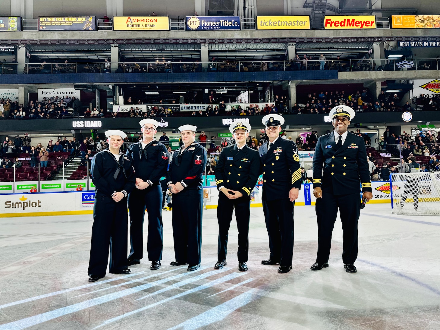 Crewmembers from the future USS Idaho (SSN 799) pose for a photo center ice during an Idaho Steelheads hockey game in Boise, Idaho, Jan. 25.