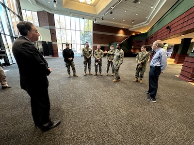 Northwest Nazarene University president Joel Pearsall greets crewmembers of the future USS Idaho (SSN 799) during a tour of the campus in Nampa, Idaho, Jan. 26.