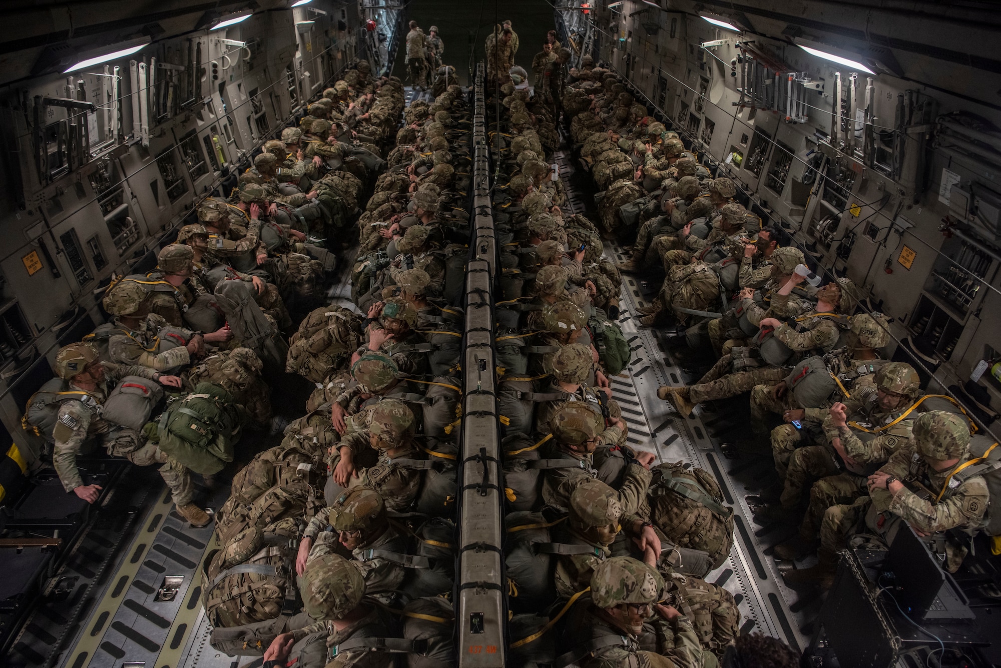 U.S. Army Soldiers from the 82nd Airborne Division prepare to enter a C-17 Globemaster III at Pope Army Airfield, North Carolina, Jan. 23, 2023. Battalion Mass Tactical Week had six aircraft participating with three C-130J Super Hercules from Dyess Air Force Base, Texas, and three C-17s from Joint Base Charleston, South Carolina. (U.S. Air Force photo by Airman 1st Class Ryan Hayman)