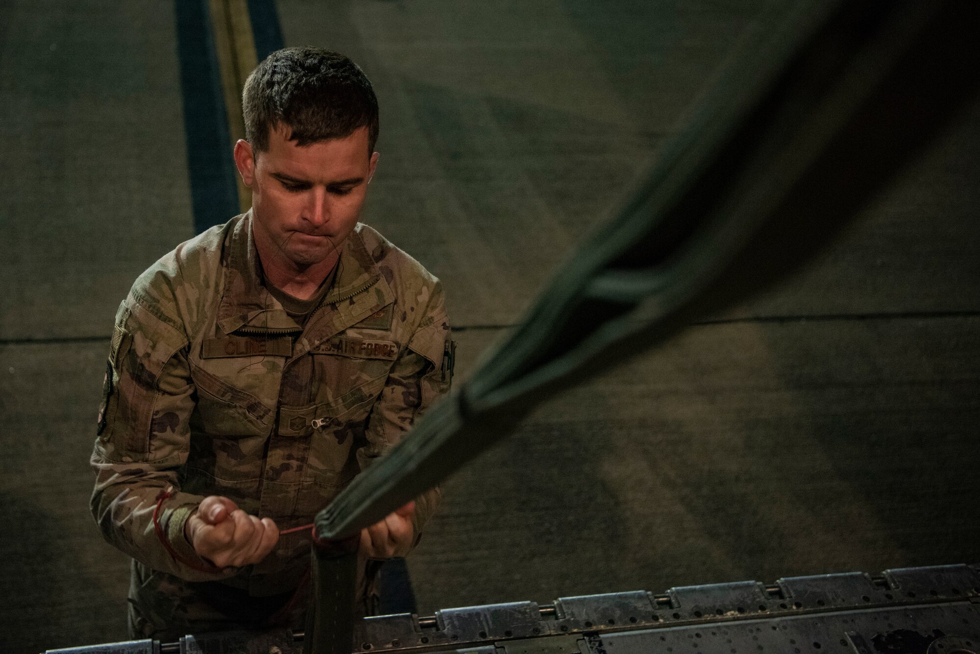 U.S. Air Force Master Sgt. Andy Cline, 40th Airlift Squadron loadmaster, ties a parachute on a C-130J Super Hercules at Pope Army Airfield, North Carolina, Jan. 26, 2023. Battalion Mass Tactical Week ensured the proper training for greater experienced Mission Planning Cells and aircrews while proactively increasing the tactical and strategic capabilities of the C-130 and C-17 Globemaster III. (U.S. Air Force photo by Airman 1st Class Ryan Hayman)