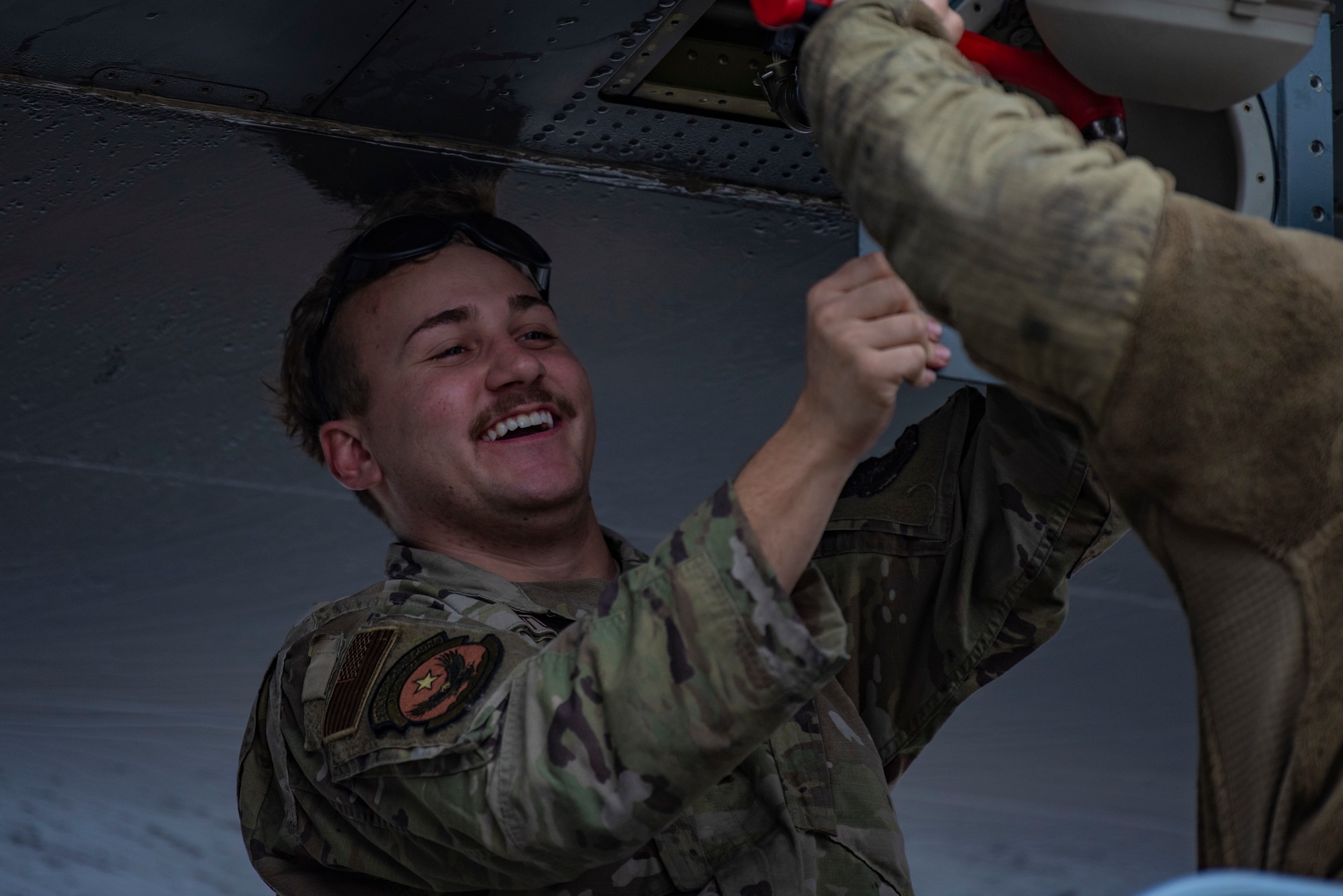 U.S. Air Force Senior Airman Derrick Studer, 317th Aircraft Maintenance Squadron crew chief, holds a panel in place on a C-130J Super Hercules at Pope Army Airfield, North Carolina, Jan. 25, 2023. During Battalion Mass Tactical Week, Studer organized and completed aircraft maintenance ensuring that each C-130 was mission capable. (U.S. Air Force photo by Airman 1st Class Ryan Hayman)