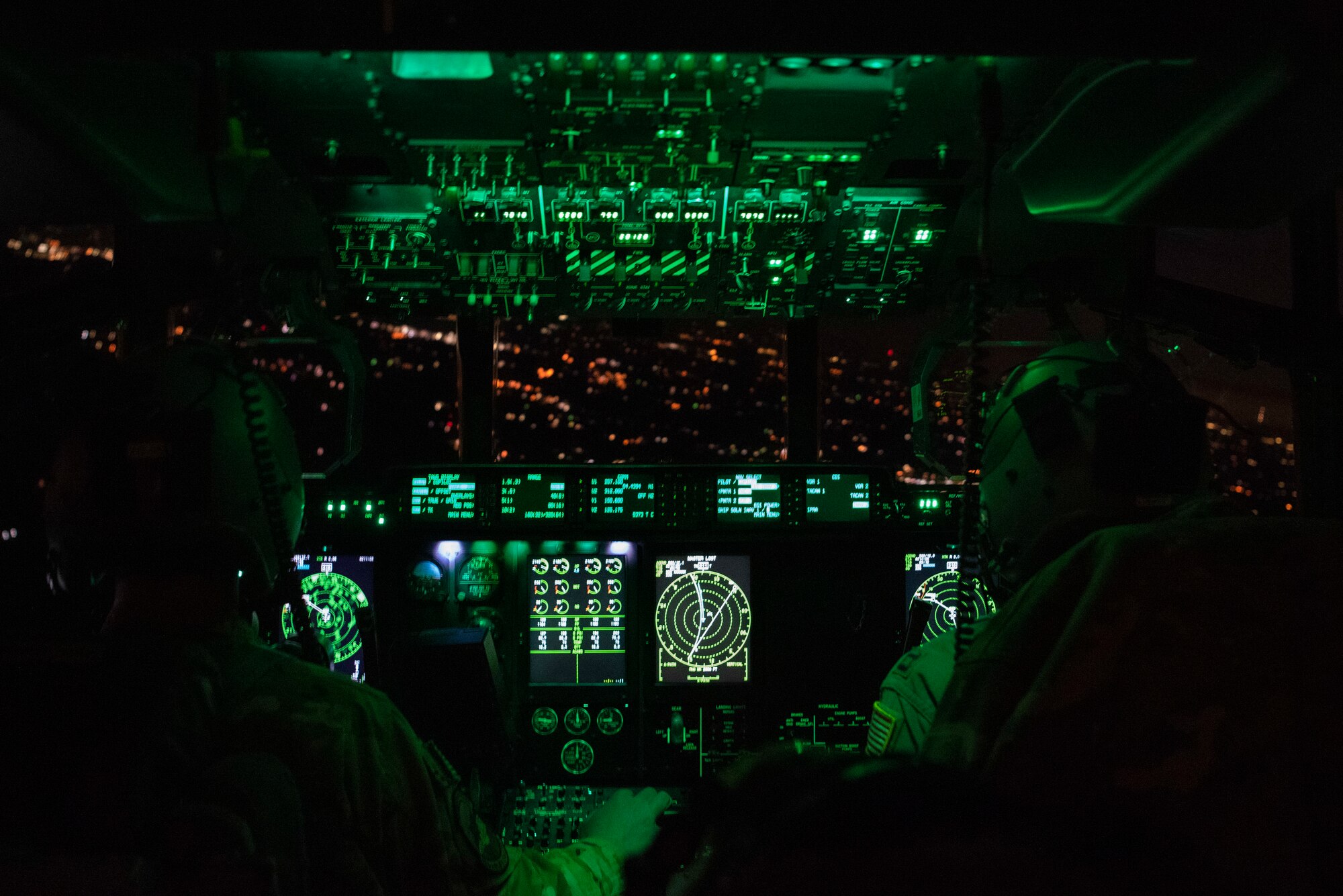 U.S. Air Force Capt. Ryan Murphy, 40th Airlift Squadron pilot, and Capt. James Wishart, 40th AS co-pilot, fly over North Carolina during Battalion Mass Tactical Week, Jan. 24, 2023. During Battalion Mass Tactical Week, the 317th Airlift Wing integrated with the 16th Airlift Squadron, Joint Base Charleston, South Carolina, and the 82nd Airborne Division, Fort Bragg, North Carolina, to train as an integrated force alongside the Army. (U.S. Air Force photo by Airman 1st Class Ryan Hayman)