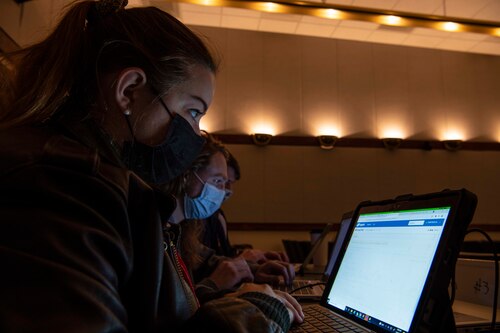 Megan Runyan, Quinn Seys, and Parker Brown, 416th Flight Test Squadron weapons integration engineers, work together for data solutions during the Data Hackathon at Edwards Air Force Base, Calif., Nov. 3, 2021. The event was Air Force Test Center’s first Data Hackathon, solving data problems sponsored by U.S. Air Force Test Pilot School, with a goal to broaden the solution reach to have a bigger mission impact. (U.S. Air Force Tech. Sgt. Tabatha Arellano)