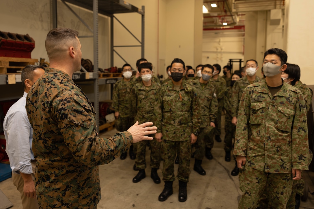 U.S. Marine Corps Chief Warrant Officer 2 Cortez Williams, an ordnance vehicle maintenance officer with 3rd Maintenance Battalion, 3rd Sustainment Group (Experimental), gives a tour to officers from the Japan Ground Self-Defense Force Ordnance School to present the advanced manufacturing capabilities of 3rd Maint. Bn. at Camp Kinser, Okinawa, Japan,  Jan. 19, 2023. 3rd MLG, based out of Okinawa, Japan, is a forward-deployed combat unit that serves as III MEF’s comprehensive logistics and combat service support backbone for operations throughout the Indo-Pacific area of responsibility. (U.S. Marine Corps photo by Lance Cpl. Weston Brown)