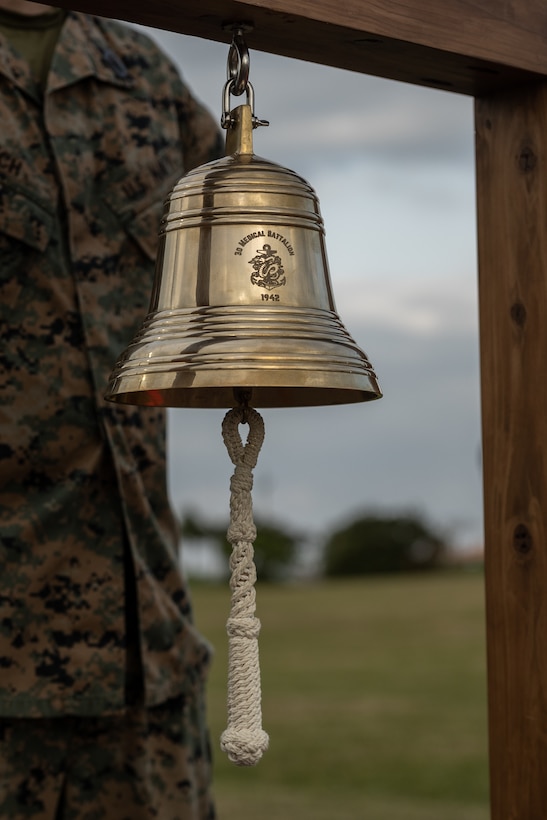 A bell waits to be rung during an appointment ceremony at Camp Kinser, Okinawa, Japan, Jan. 20, 2023. During the ceremony, U.S. Navy Command Master Chief Nathan Chun assumed his position as command master chief of 3rd Marine Logistics Group (MLG). 3rd MLG, based out of Okinawa, Japan, is a forward-deployed combat unit that serves as III Marine Expeditionary Force’s comprehensive logistics and combat service support backbone for operations throughout the Indo-Pacific area of responsibility. (U.S. Marine Corps photo by Lance Cpl. Sydni Jessee)