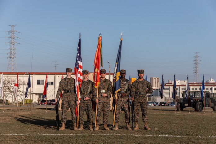 U.S. Marines and a Sailor with the 3rd Marine Logistics Group (MLG) color guard stand at parade rest during a change of command ceremony at Camp Foster, Okinawa, Japan, Jan. 31, 2023. During the ceremony, Capt. Darryl Arfsten, the outgoing commanding officer, relinquished command of 3rd Medical Battalion to Capt. Justin C. Logan, the oncoming commanding officer. 3rd MLG, based out of Okinawa, Japan, is a forward-deployed combat unit that serves as III Marine Expeditionary Force’s comprehensive logistics and combat service support backbone for operations throughout the Indo-Pacific area of responsibility. (U.S. Marine Corps photo by Lance Cpl. Sydni Jessee)