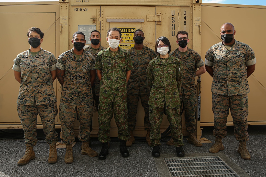 U.S. Marines with 3rd Sustainment Group (Experimental), 3rd Marine Logistics Group, and Maj. Gen. Masayoshi Sakamoto, middle left, the commandant of the Japan Ground Sefl-Defense Force Ordnance School, and Maj. Yakako Nakajima, middle right, a member of the JGSDF, pose for a group photo at Camp Kinser, Okinawa, Japan, Sep. 14, 2022.  3rd MLG, based out of Okinawa, Japan, is a forward-deployed combat unit that serves as III MEF’s comprehensive logistics and combat service support backbone for operations throughout the Indo-Pacific area of responsibility. (U.S. Marine Corps photo by Lance Cpl. Weston Brown)