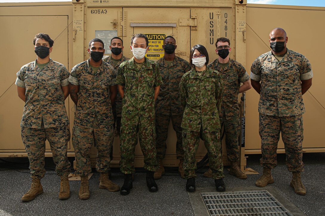 U.S. Marines with 3rd Sustainment Group (Experimental), 3rd Marine Logistics Group, and Maj. Gen. Masayoshi Sakamoto, middle left, the commandant of the Japan Ground Sefl-Defense Force Ordnance School, and Maj. Yakako Nakajima, middle right, a member of the JGSDF, pose for a group photo at Camp Kinser, Okinawa, Japan, Sep. 14, 2022.  3rd MLG, based out of Okinawa, Japan, is a forward-deployed combat unit that serves as III MEF’s comprehensive logistics and combat service support backbone for operations throughout the Indo-Pacific area of responsibility. (U.S. Marine Corps photo by Lance Cpl. Weston Brown)