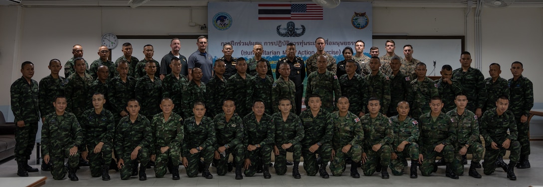 Instructors and students of the Humanitarian Mine Action (HMA) Thailand Explosive Ordnance Disposal (EOD) level 1-2 course take a photo during its opening ceremony at Fort Bhanurangsi, Ratchaburi, Thailand, November 14, 2022. Royal Thai and American Armed Forces work together to train TMAC students in EOD level 1-2 in order to develop an EOD capacity to assist TMAC’s mission of becoming landmine free. This partnership is aligned with the U.S. Department of Defense’s Humanitarian Mine Action Program, which assists partnered nations affected by landmines, explosive remnants of war, and the hazardous effects of unexploded ordnance. (U.S. Marine Corps photo by Cpl. Moises Rodriguez)