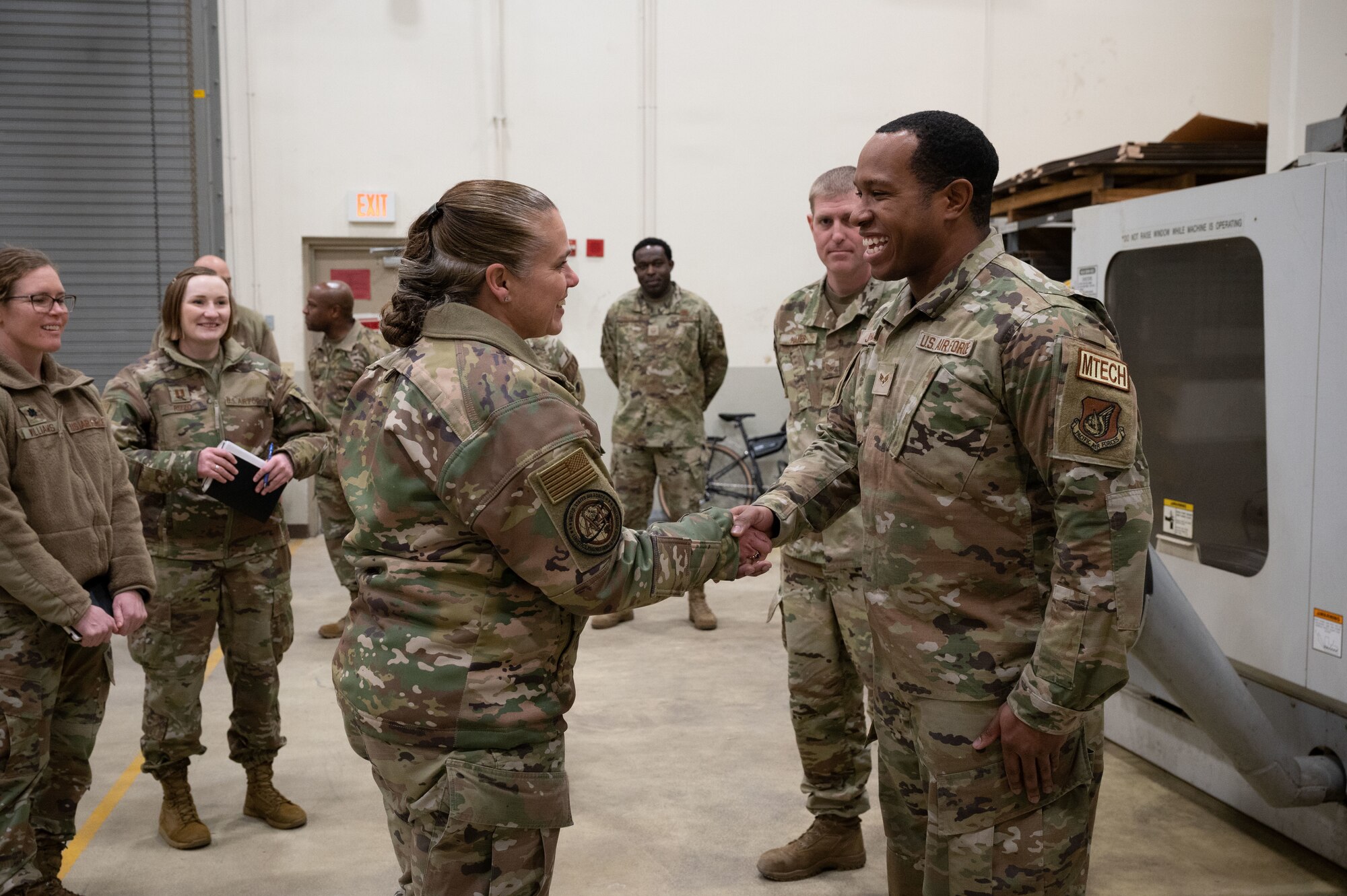 Maj. Gen. Linda S. Hurry (left), director of logistics, deputy chief of staff for logistics, engineering and force protection, Headquarters Air Force, coins Senior Airman Shawn Johnson, 8th Maintenance Squadron aircraft metals technology technician, at Kunsan Air Base, Republic of Korea, Feb. 1, 2023. Hurry recognized several Wolf Pack Airmen for establishing process improvements in their unit. (U.S. Air Force photo by Staff Sgt. Sadie Colbert)