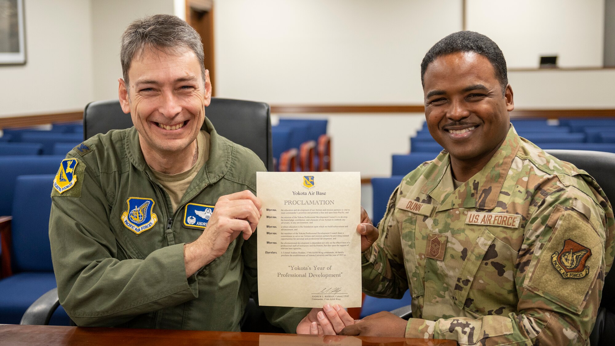 Wing leadership pose for a photo while displaying the signed declaration