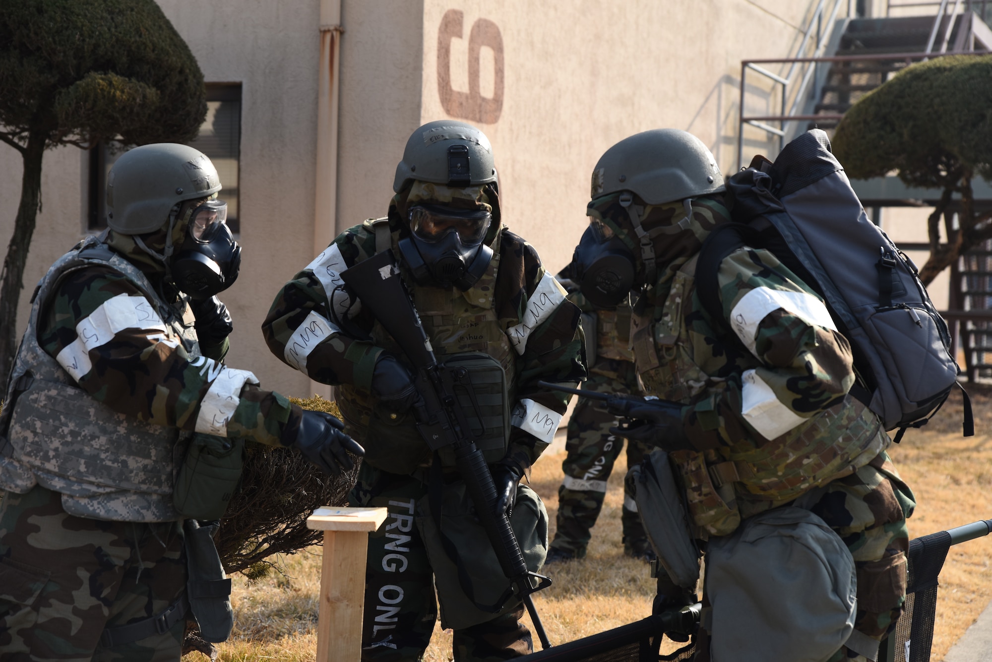 U.S. Air Force Airmen from the 51st Force Support Squadron check for simulated chemicals during a post-attack reconnaissance (PAR) sweep during a training event at Osan Air Base, Republic of Korea, Feb. 1, 2023. PAR sweeps are conducted following an attack to check for any possible hazards within a perimeter surrounding structures. (U.S. Air Force photo by 1st Lt Michelle Chang)