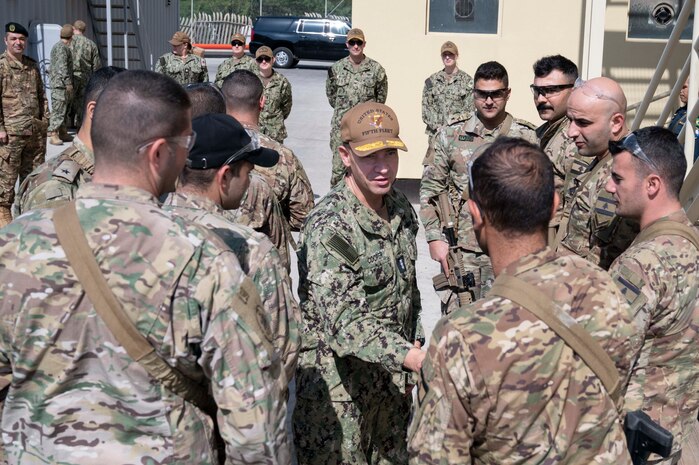 230131-N-ZA692-2028 MANAMA, Bahrain (Jan. 31, 2023) Vice Adm. Brad Cooper, commander of U.S. Naval Forces Central Command, U.S. 5th Fleet and Combined Maritime Forces, greets members of the Lebanese Navy visiting Bahrain to attend a vessel boarding course at the U.S. Navy base, Jan. 31.