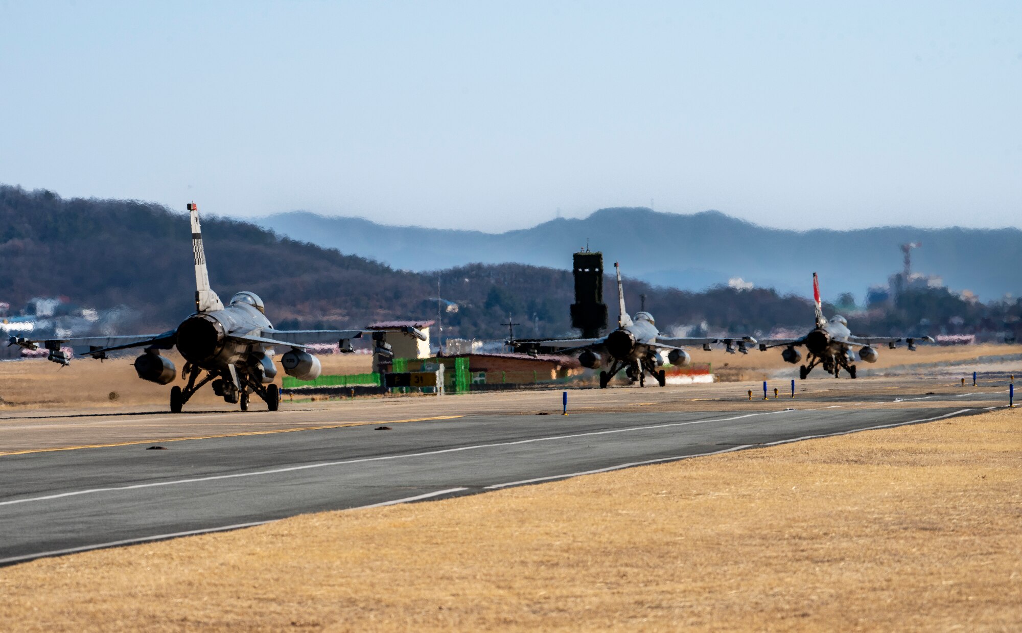 Three U.S. Air Force F-16 Fighting Falcons, 36th Fighter Squadron, taxi on the runway after landing during a training event at Daegu Air Base, Republic of Korea, Jan. 30, 2023.