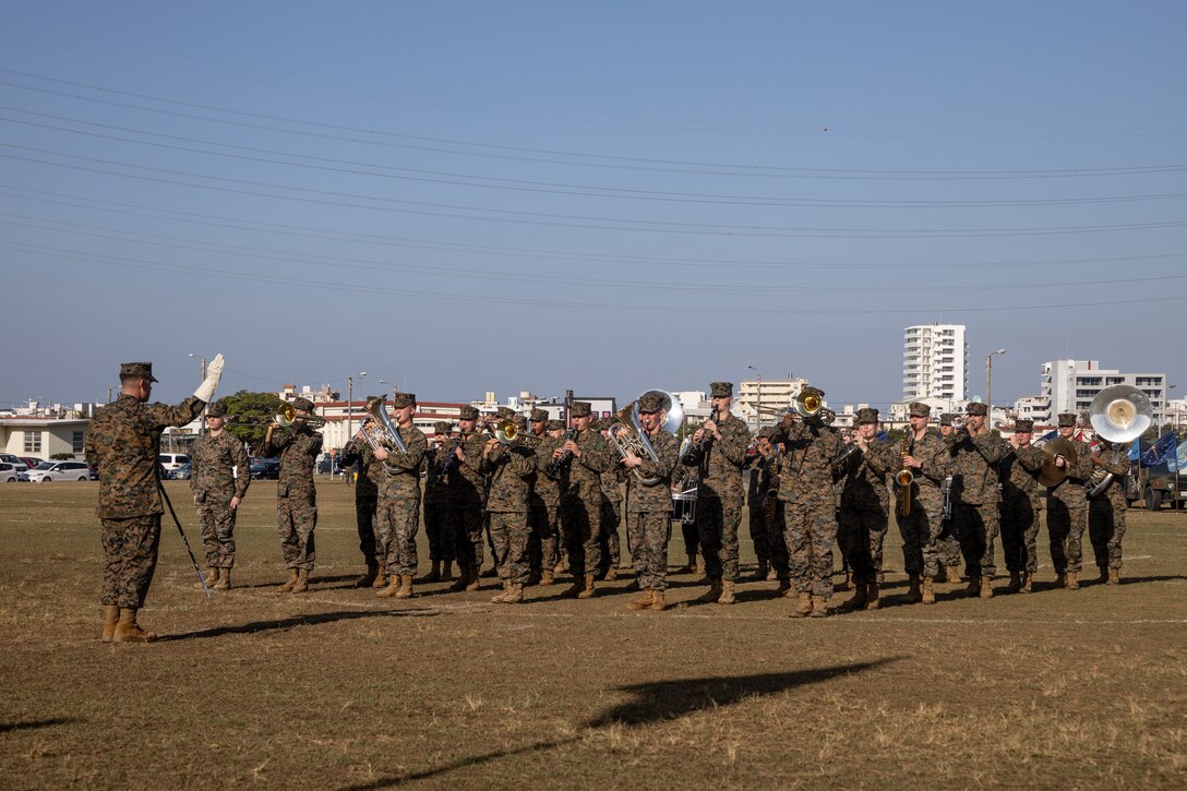 The U.S. Marine Corps III Marine Expeditionary Force band plays Anchors Aweigh during a change of command ceremony at Camp Foster, Okinawa, Japan, Jan. 31, 2023. During the ceremony, Capt. Darryl Arfsten, the outgoing commanding officer, relinquished command of 3rd Medical Battalion to Capt. Justin C. Logan, the oncoming commanding officer. 3rd Marine Logistics Group, based out of Okinawa, Japan, is a forward-deployed combat unit that serves as III Marine Expeditionary Force’s comprehensive logistics and combat service support backbone for operations throughout the Indo-Pacific area of responsibility. (U.S. Marine Corps photo by Lance Cpl. Sydni Jessee)