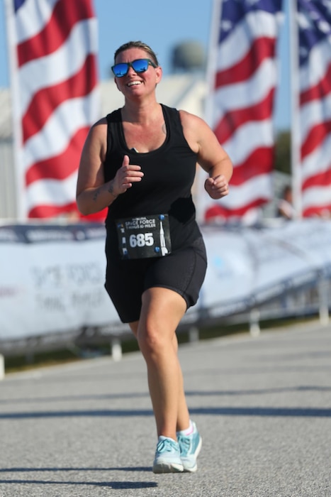 U.S. Air Force Master Sgt. Crystal Fulco, a 125th Logistics Readiness Squadron quality assurance manager, runs the U.S. Space Force T-Minus 10-Miler held at Cape Canaveral Space Force Station, Florida, Dec. 10, 2022. Fulco started running as a way to get fit after the birth of her son but her goal soon morphed into a more rigorous challenge to run a half or full marathon in every U.S. state. So far, she’s completed 17 half marathons and two full marathons netting more than 275 miles in eight states. (Courtesy photo)