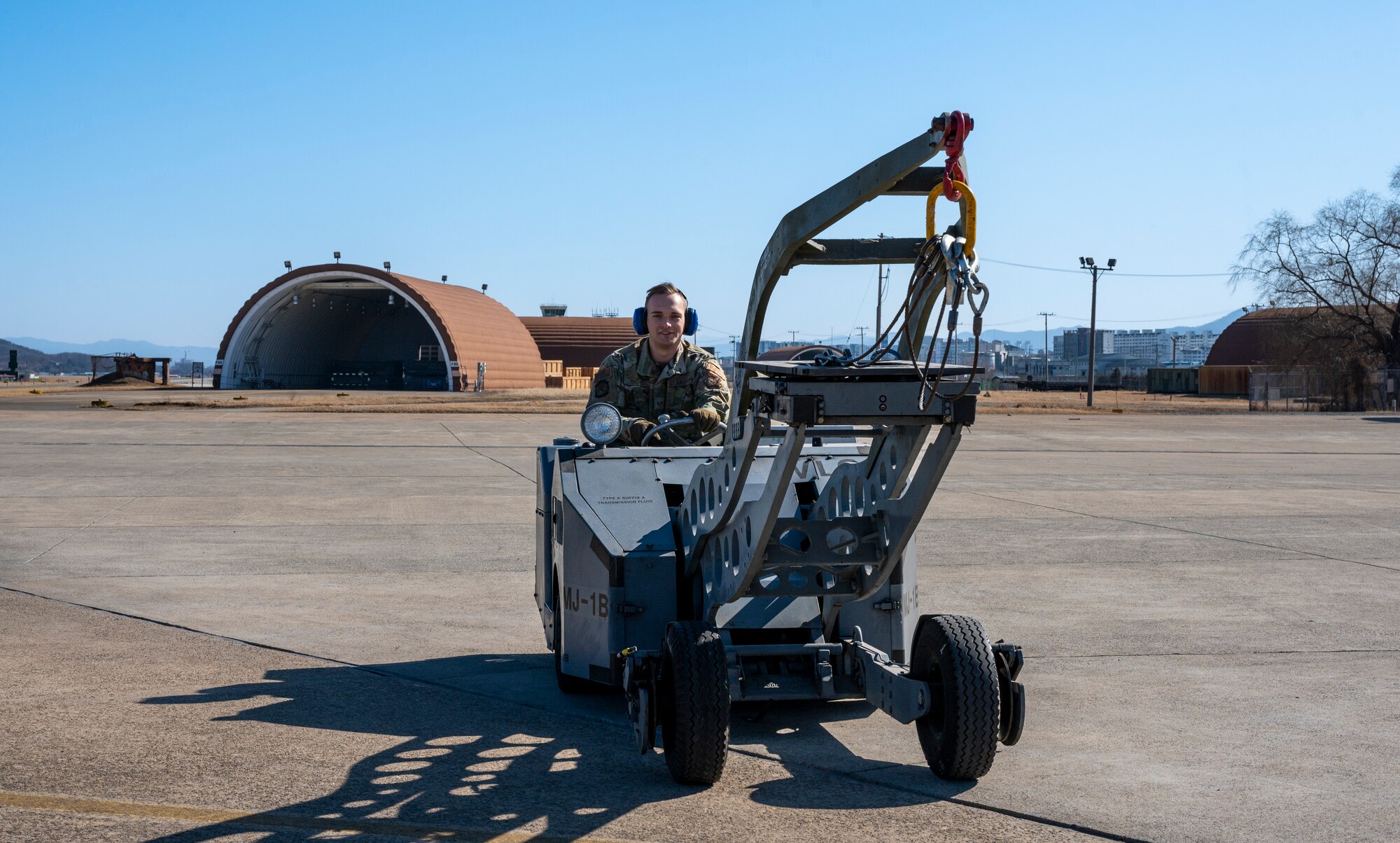 U.S. Air Force Staff Sgt. Christian Mathes, 51st Munition Squadron maintenance supervisor, operates a MJ-1C weapons loader during a training event at Daegu Air Base, Republic of Korea, Jan. 30, 2023.