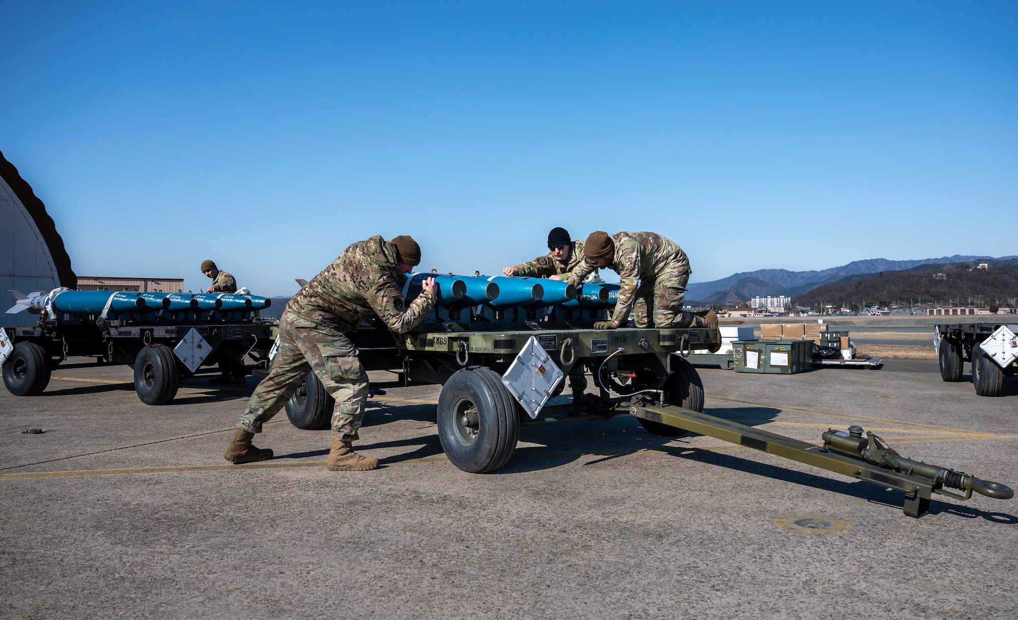 U.S. Air Force Airmen assigned to the 51st Munitions Squadron (MUNS) build and load simulated GBU-38 Joint Direct Attack Munitions during a training event at Daegu Air Base, Republic of Korea, Jan. 30, 2023.