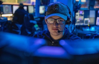 Operations Specialist 3rd Class Tyberious Whitecotton stands watch in the combat information center aboard USS Roosevelt (DDG 80) in the North Sea.