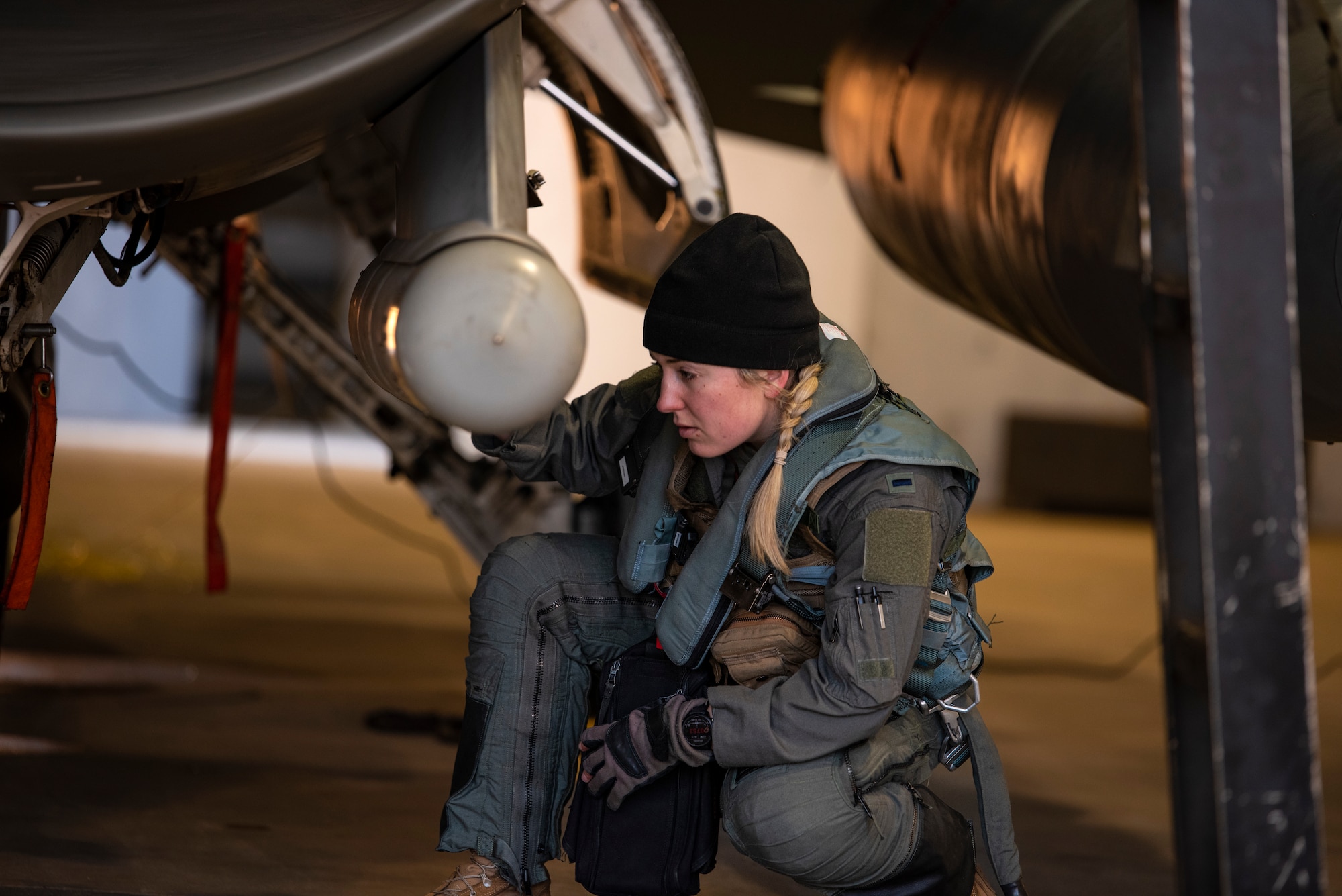 U.S. Air Force 1st Lt. Demi Yurcisin, 36th Fighter Squadron pilot, performs pre-flight checks on an F-16 Fighting Falcon during a routine training event at Daegu Air Base, Republic of Korea, Jan. 31, 2023.