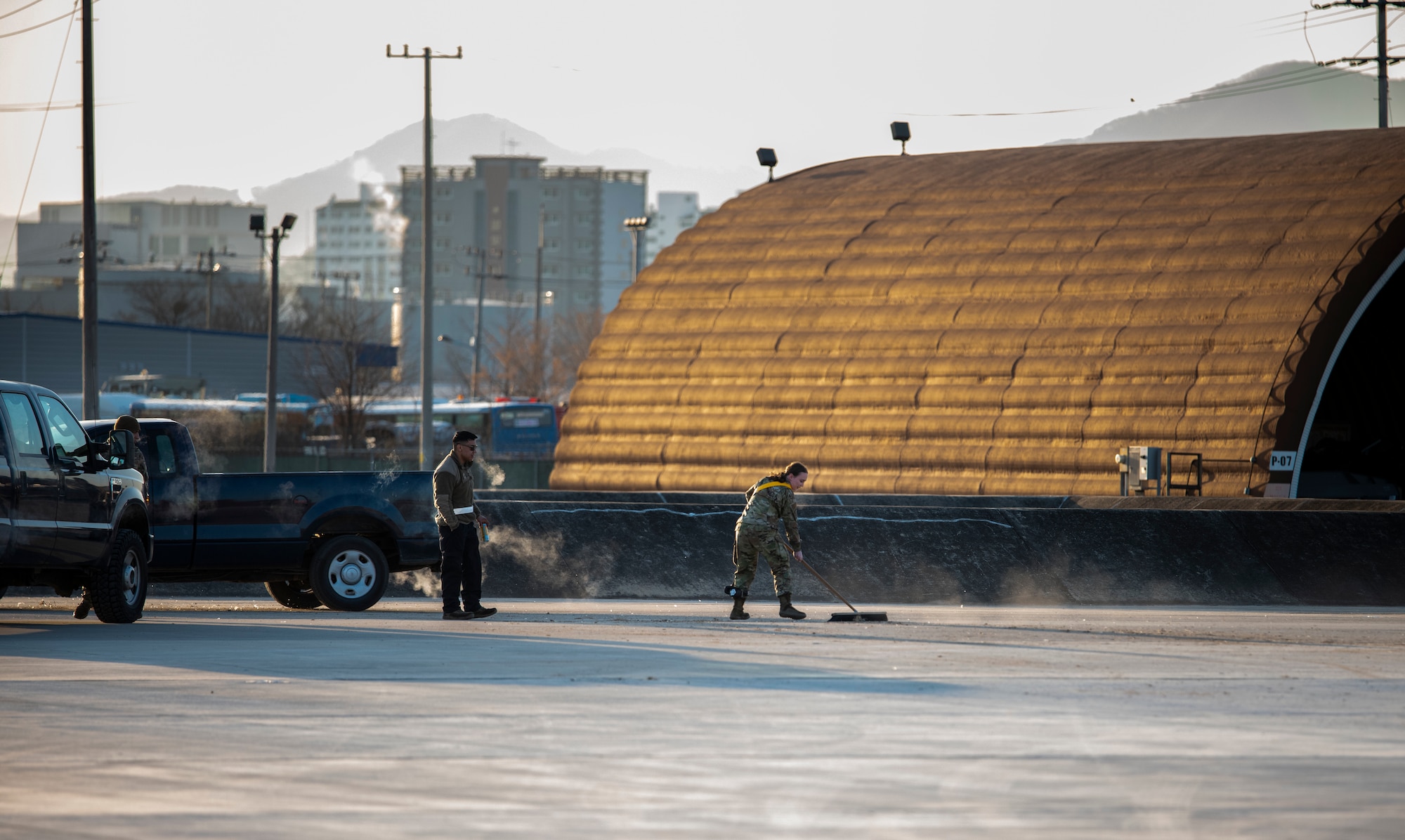 U.S. Air Force Senior Airman Jessica Daniels, 36th Fighter Generation Squadron weapons load crew member, clears debris on the flight line during a training event at Daegu Air Base, Republic of Korea, Jan. 31, 2023.