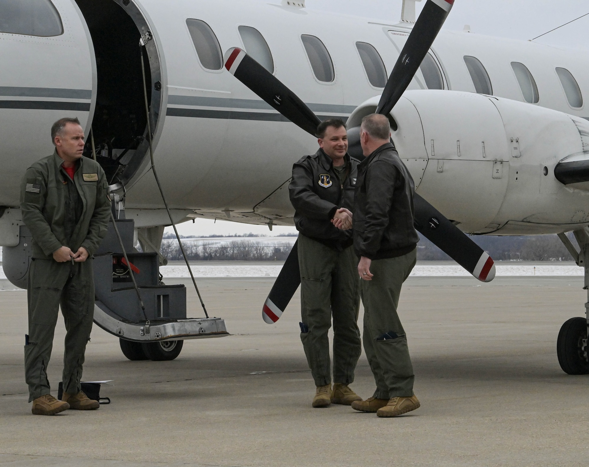 Col. Travis Crawmer (right), 132d Wing commander, congratulates the crew of the RC-26 Condor upon completing the final mission at the 132d Wing, January 27, 2023, in Des Moines, Iowa. The RC-26 Condor operated at the Des Moines Airbase since 2015 and provided counter-narcotics and domestic natural disaster support for law enforcement and emergency management. (U.S. Air National Guard photo by Senior Master Sgt. Robert Shepherd)