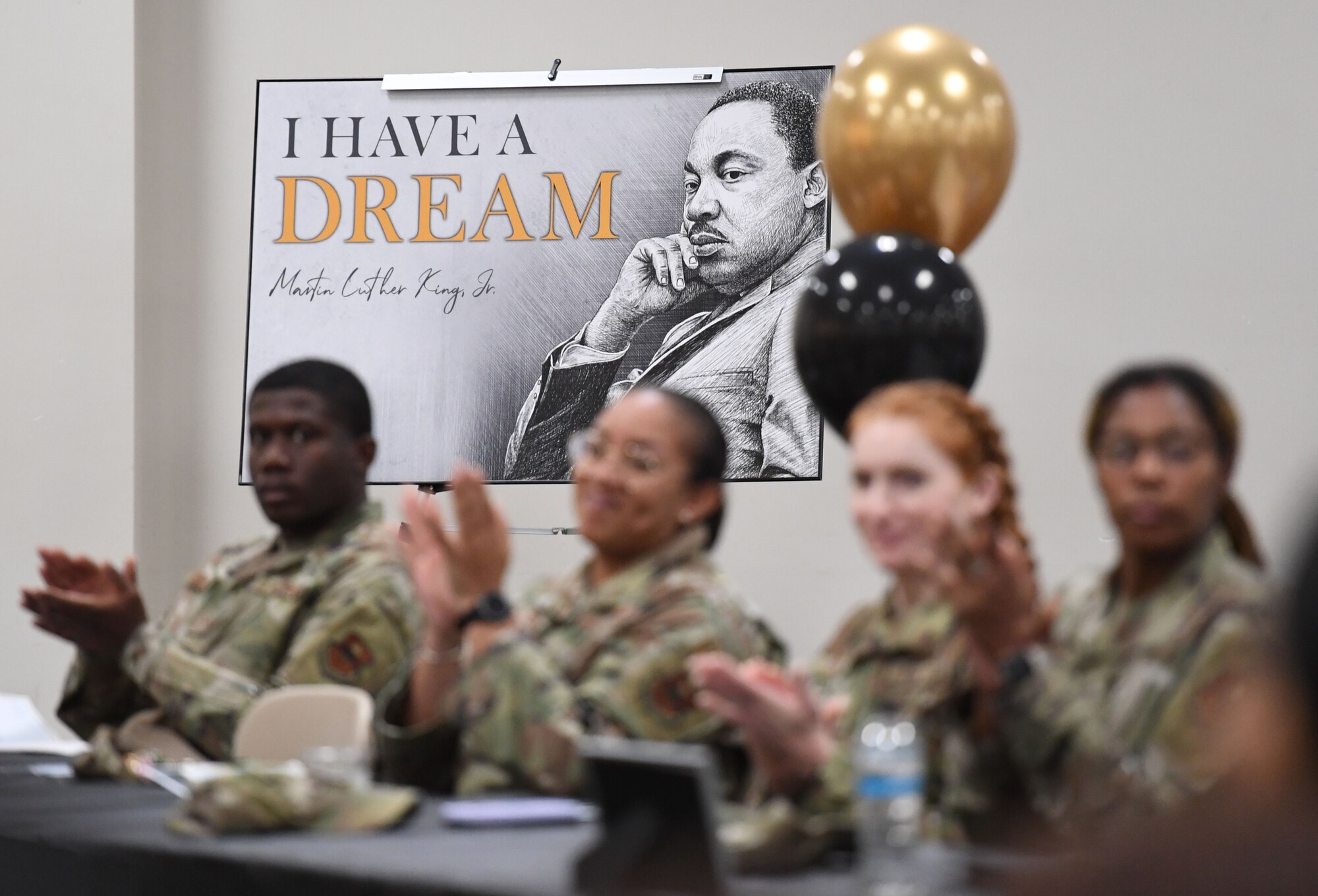 A poster is on display at the annual Dr. Martin Luther King Jr.  Luncheon inside the Roberts Consolidated Aircraft Maintenance Facility at Keesler Air Force Base, Mississippi, Jan. 30, 2023.