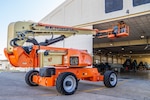 Workers move crane into hanger.