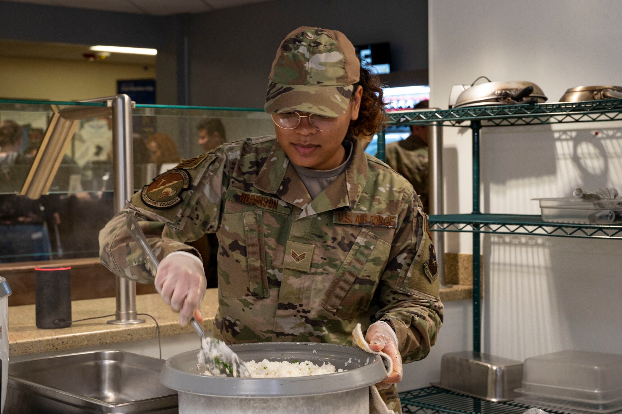 U.S. Air Force Senior Airman Paige Robinson, 49th Force Support Squadron food services journeyman, prepares a batch of cilantro rice at the 49er Cafe, Holloman Air Force Base, New Mexico, Feb. 1, 2023.