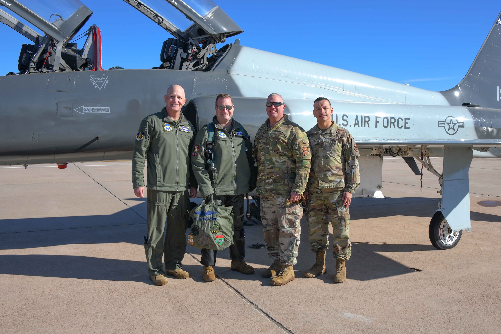 From left, U.S. Air Force Col. Blaine Baker, 97th Air Mobility Wing commander, Maj. Gen. Phillip Stewart, 19th Air Force commander, Chief Master Sgt. Justin Apticar, 19th AF command chief, and Chief Master Sgt. Cesar Flores, 97th AMW command chief, pose for a photo at Altus Air Force Base, Oklahoma, Jan. 25, 2023. Officials from 19th Air Force toured the base and met with many Airmen to learn more about the wing’s mission. (U.S. Air Force photo by Airman 1st Class Kari Degraffenreed)
