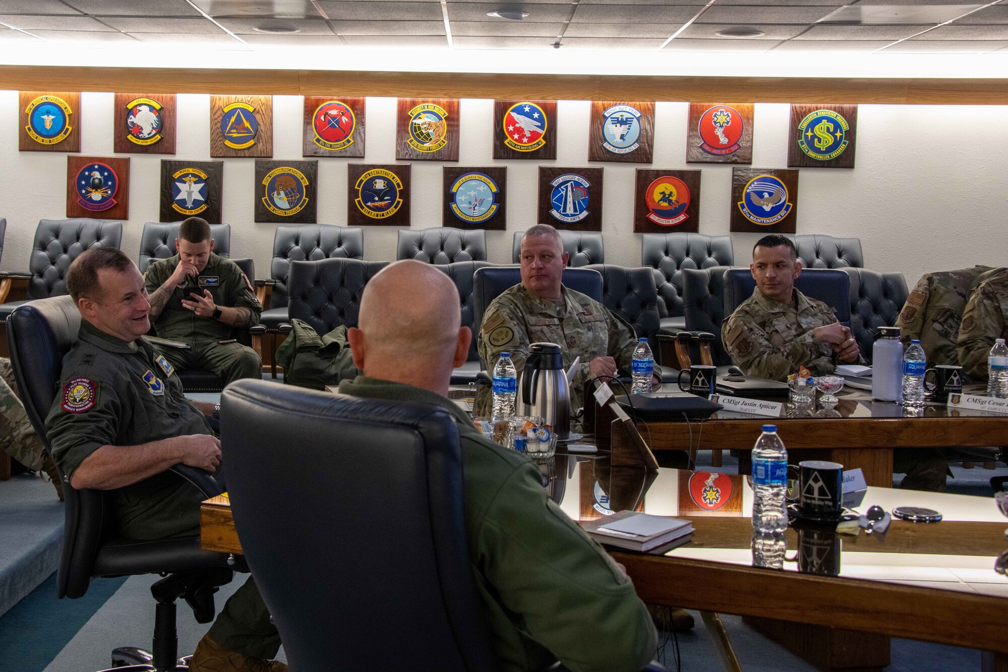 Leaders from the 97th Air Mobility Wing and 19th Air Force talk during a visit at Altus Air Force Base, Oklahoma, Jan. 25, 2023. Leaders from 19th AF toured AAFB, learned about the 97th AMW mission, and met the Airmen who accomplish the mission. (U.S. Air Force photo by Airman 1st Class Kari Degraffenreed)