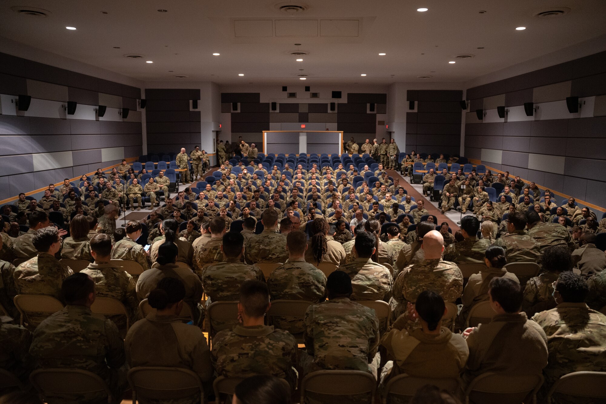 Multiple U.S. Air Force members in a auditorium.