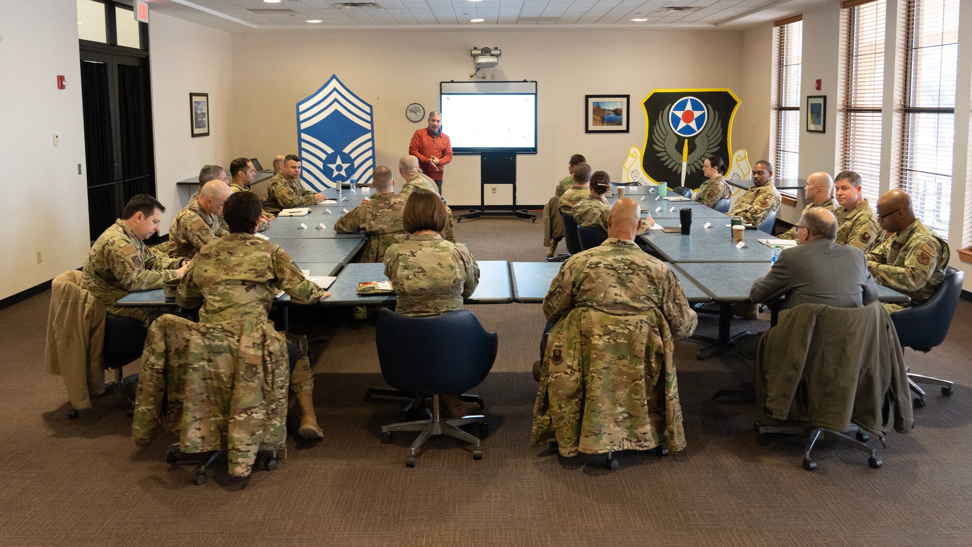 A Civilian briefs multiple U.S. Air Force members.