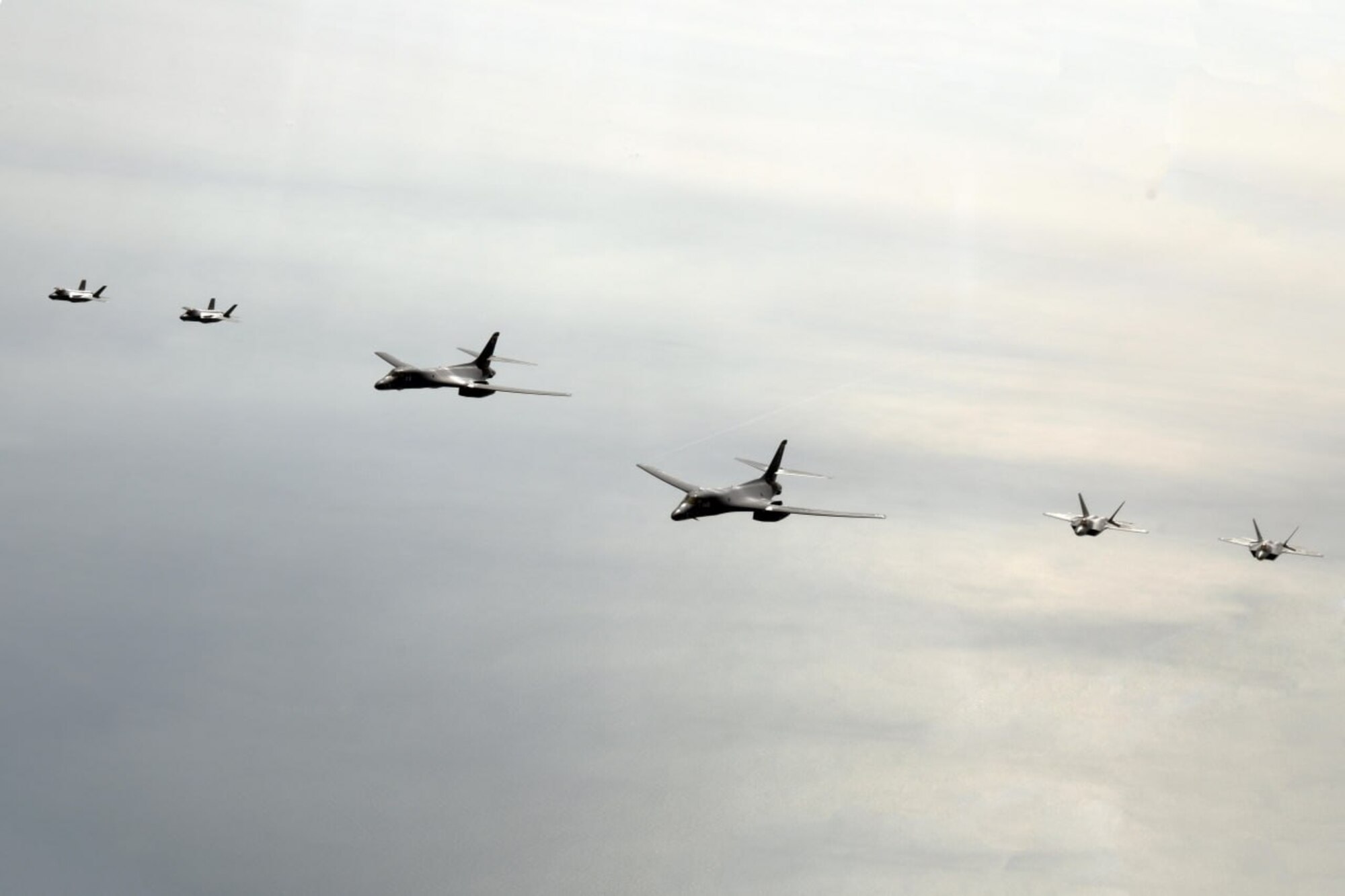 A photo of United States Air Force B-1s and F-22s