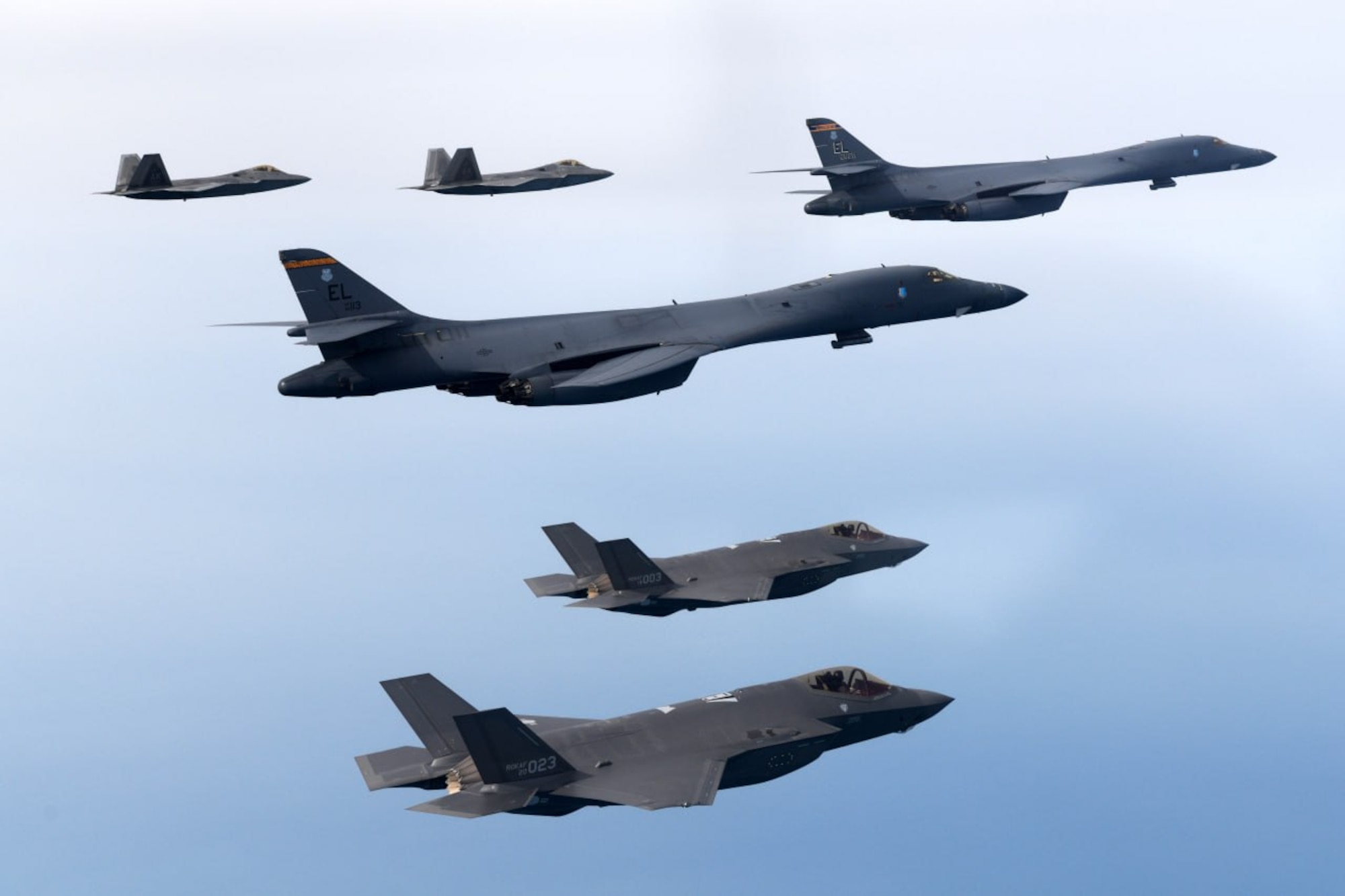 A photo of United States Air Force B-1s and F-22s