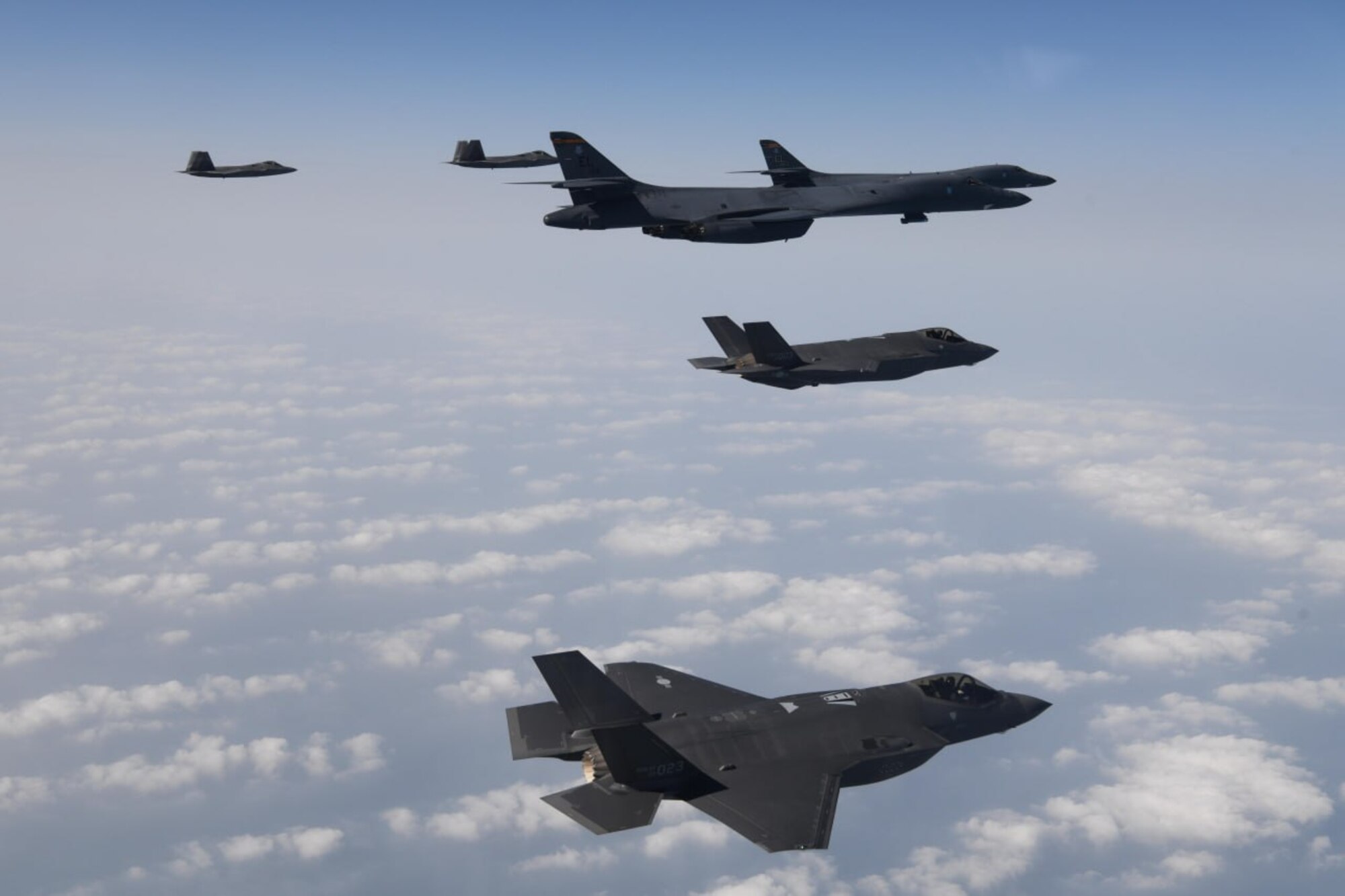 A photo of United States Air Force B-1s and F-22s