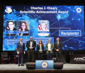 The Air Force Research Laboratory’s Materials and Manufacturing Directorate, or RX, Director Darrell Phillipson, far left, and Chief Scientist Dr. Richard Vaia, far right, pose with award recipients, from left to right, Dr. Matthew Dickerson, Dr. Lisa Rueschhoff and Dr. Abigail Juhl at the 70th Annual RX Awards Ceremony Jan. 27, 2022, at the Air Force Institute of Technology’s Kenney Hall. The team of Dickerson and Rueschhoff tied with Juhl for the directorate’s most prestigious honor, the Charles J. Cleary Scientific Achievement Award, for the first time in the organization’s history. The Cleary Award acknowledges exemplary research published or accepted for publication, in a recognized, refereed journal. (U.S. Air Force photo / Jonathan Taulbee).